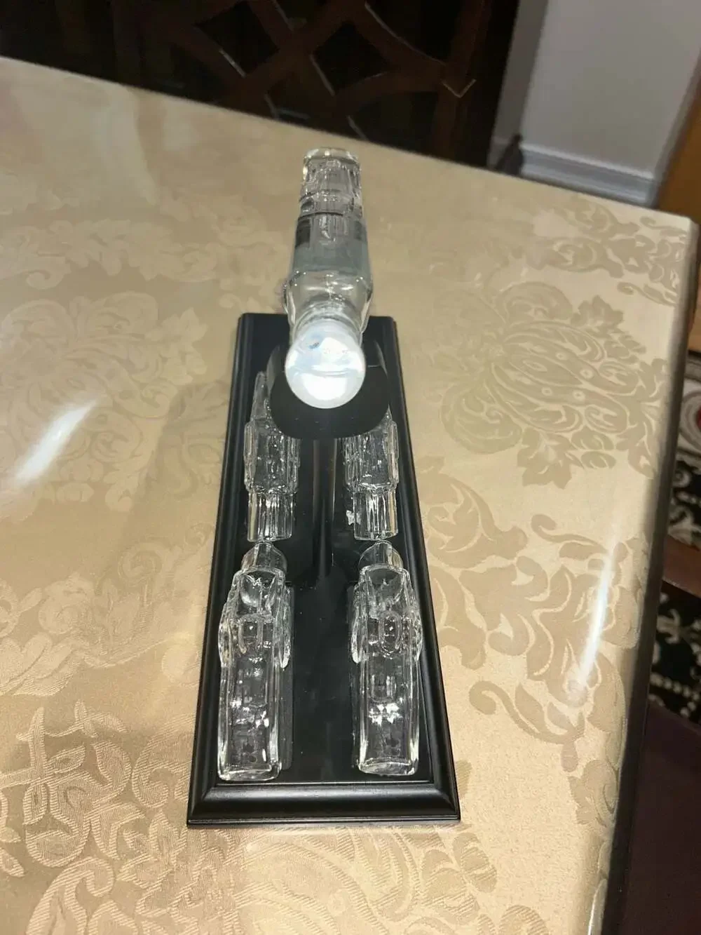 Clear Glass Pistol Decanter Set with Four Glass Shot Glasses on Display Stand